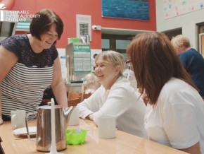 Three women laughing in a cafe