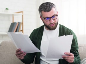 a man inspecting his energy bills