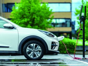 an electric vehicle charging at a charge point