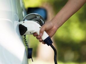 a person charging an electric vehicle