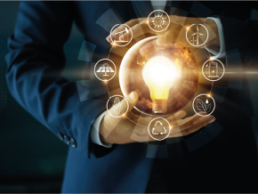 A man holding a lightbulb surrounded by different symbols of renewable energy