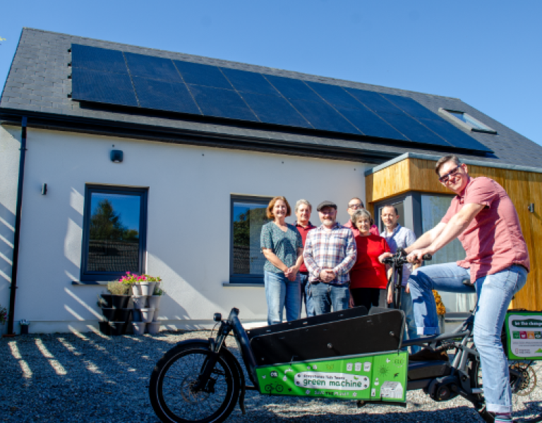 Family outside house with solar pv