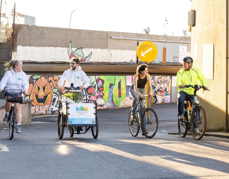 Four people riding bikes