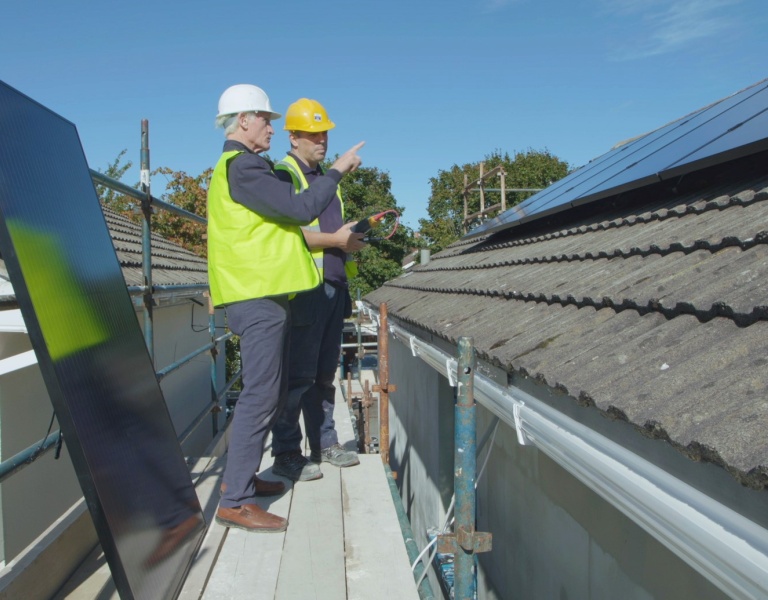 Engineers inspecting solar PV panels