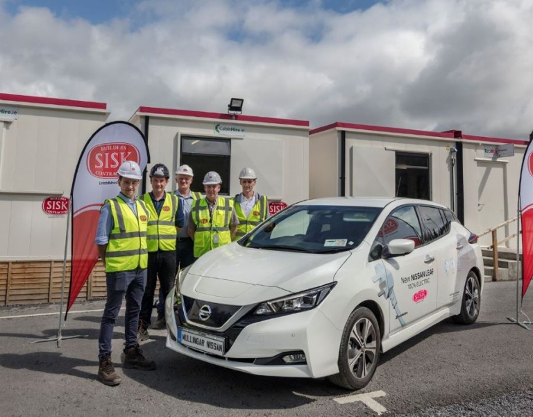 SIsk staff standing with their new EV