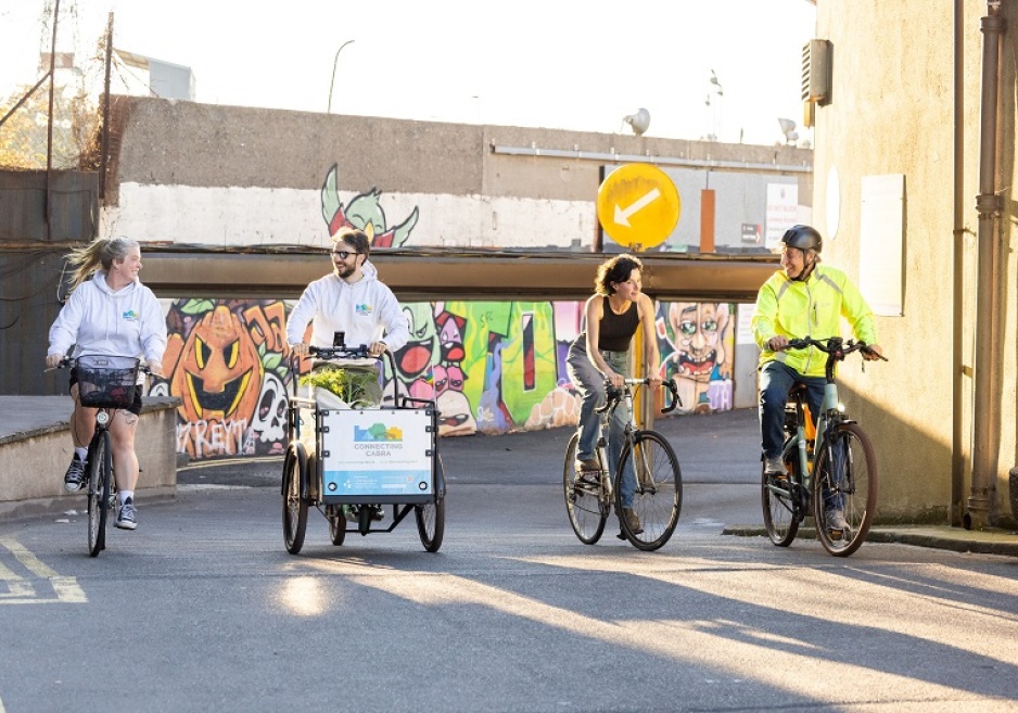 Four people riding bikes