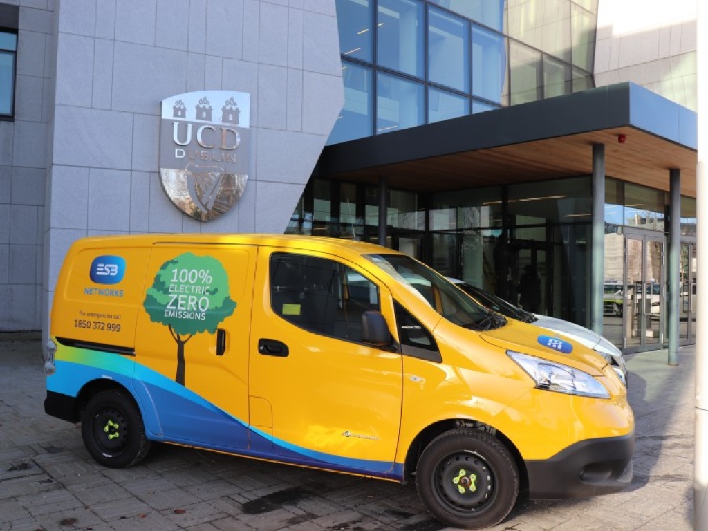 A yellow ESB van parked outside of the UCD main entrance