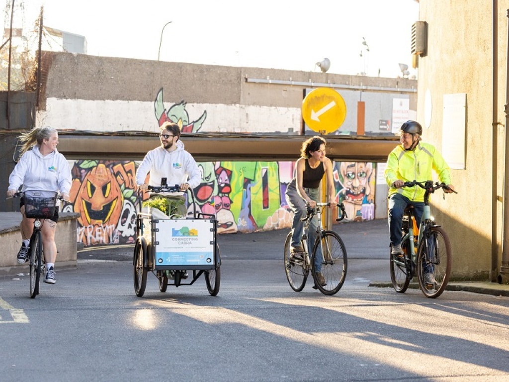 Four people riding bikes