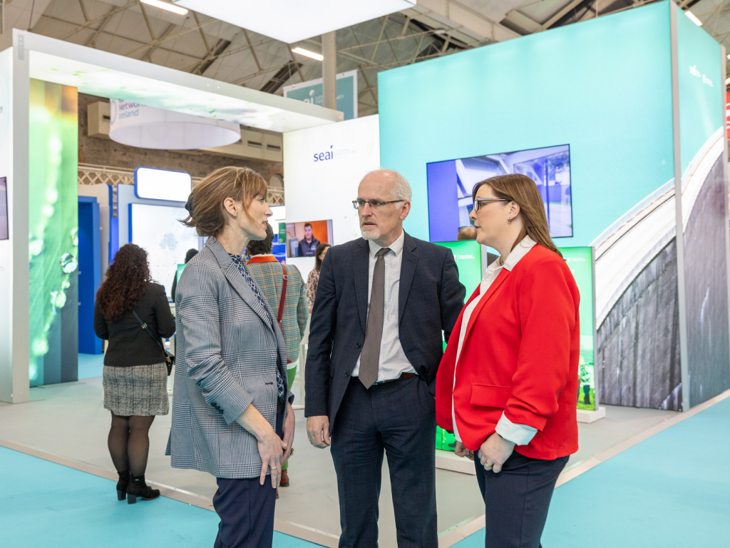 An SEAI expert speaking to an energy show attendee at an exhibition stand