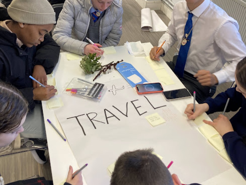 School students working together at a desk at an SEAI schools workshop