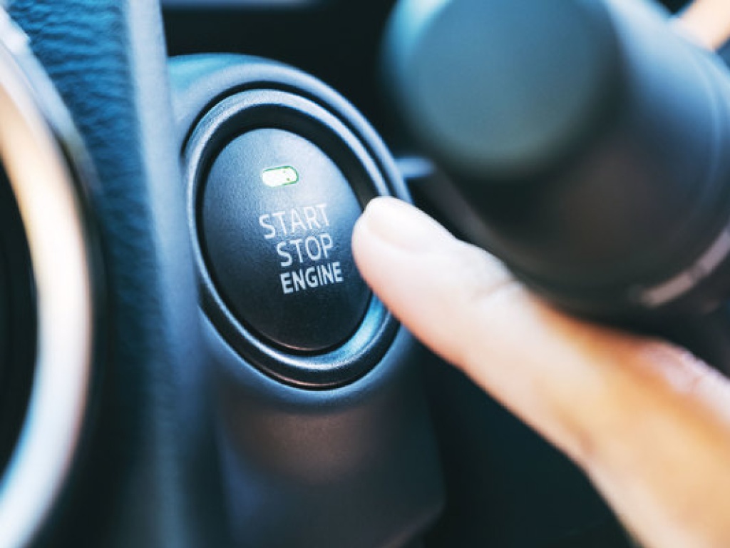 a person pressing the button to start an electric vehicle