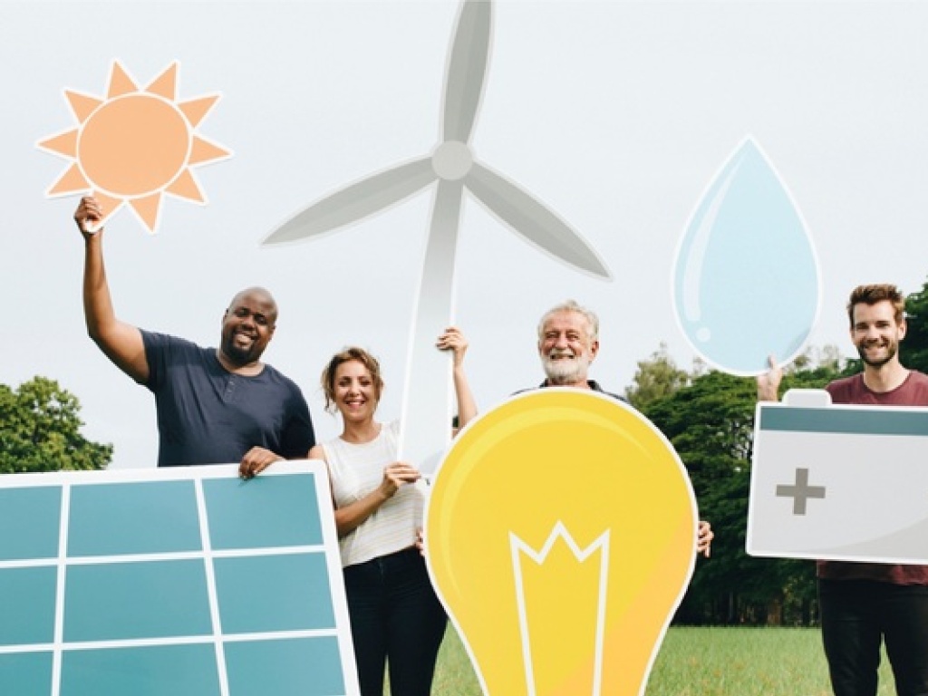 people holding symbols of renewable energy like solar panels, wind turbines and a lightbulb