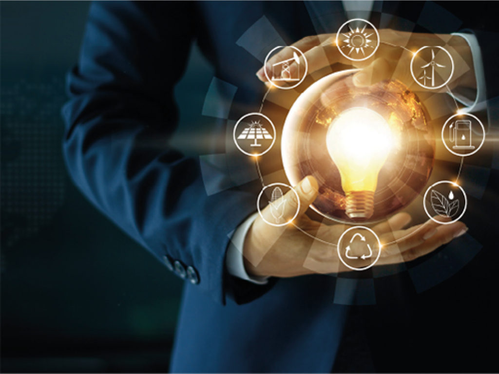 A man holding a lightbulb surrounded by different symbols of renewable energy